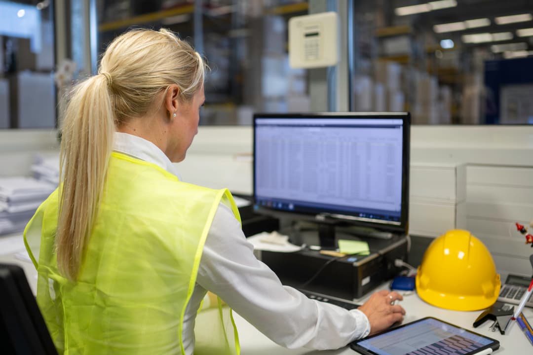 Operations manager reviewing warehouse performance data and analytics to regain control and visibility in 3PL operations